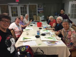 Group photo of Houston artist Tasnuva Rahman teaching an art class for elderly residents at Brookdale Retirement in Tomball, TX