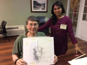 A resident at Brookdale Retirement in Tomball, TX with his project. Houston artist Tasnuva Rahman gives back to the community by teaching an art class.
