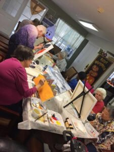Elderly residents at Brookdale Retirement in Tomball, TX enjoy working on their art projects. Houston artist Tasnuva Rahman gives back to the community by teaching an art class.