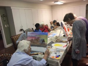Elderly residents at Brookdale Retirement in Tomball, TX working on their art projects. Houston artist Tasnuva Rahman gives back to the community by teaching an art class.