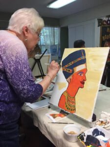 An elderly resident at Brookdale Retirement in Tomball, TX working on her art project. Houston artist Tasnuva Rahman gives back to the community by teaching an art class.