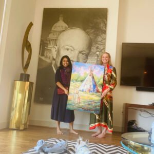Houston artist Tasnuva Rahman presenting the finished custom portrait painting to a very happy Mrs. Peacock.